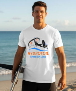 Man on a sunny beach wearing a white Hydrofoil T-Shirt featuring a wing foiling graphic print