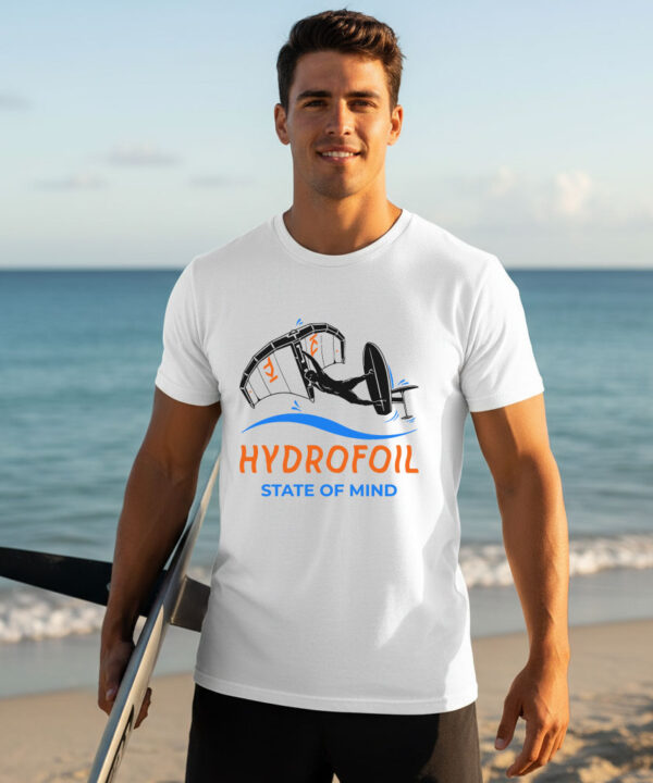 Man holding a hydrofoil board on a sunny beach wearing a white premium hydrofoil graphic t-shirt