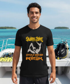 Premium Shark Zone Scuba Diving T-Shirt in black worn on a boat deck with diving gear.