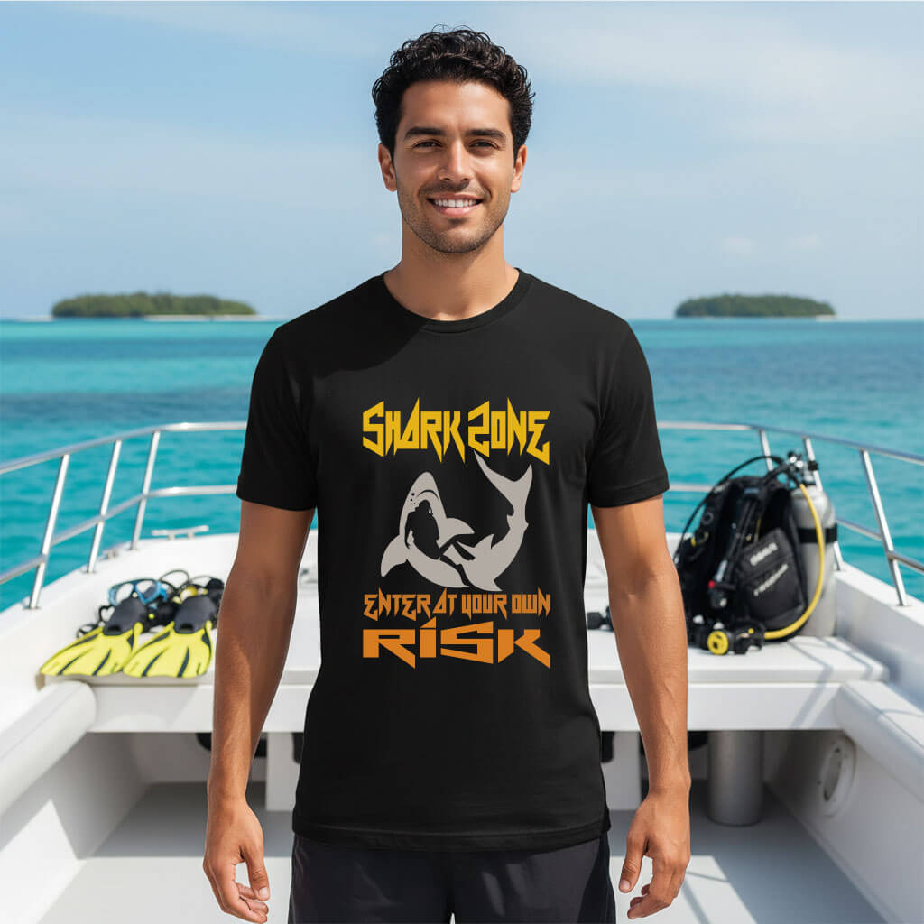 Premium Shark Zone Scuba Diving T-Shirt in black worn on a boat deck with diving gear.