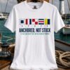 White unisex sailing tee with nautical signal flags spelling STUCK and Anchored Not Stuck sailor humor graphic