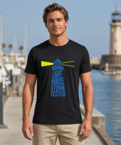Storm tested lighthouse shirt design close-up, blue typographic lighthouse graphic on black cotton tee
