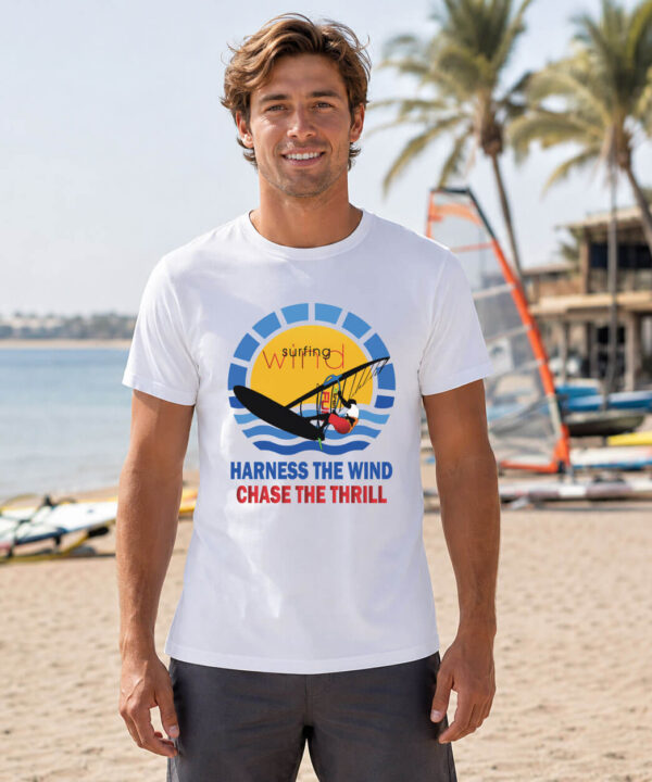 Man wearing white windsurfing t-shirt with sunburst wind-sport graphic and Harness the Wind text on beach