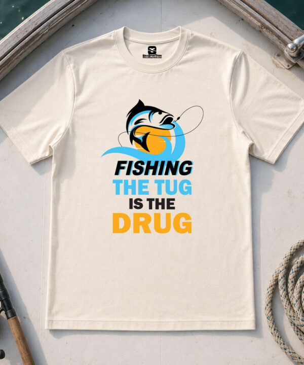 Fishing the Tug Is the Drug shirt on natural tee — bold fish graphic and typography — Seasportees fishing lifestyle tee