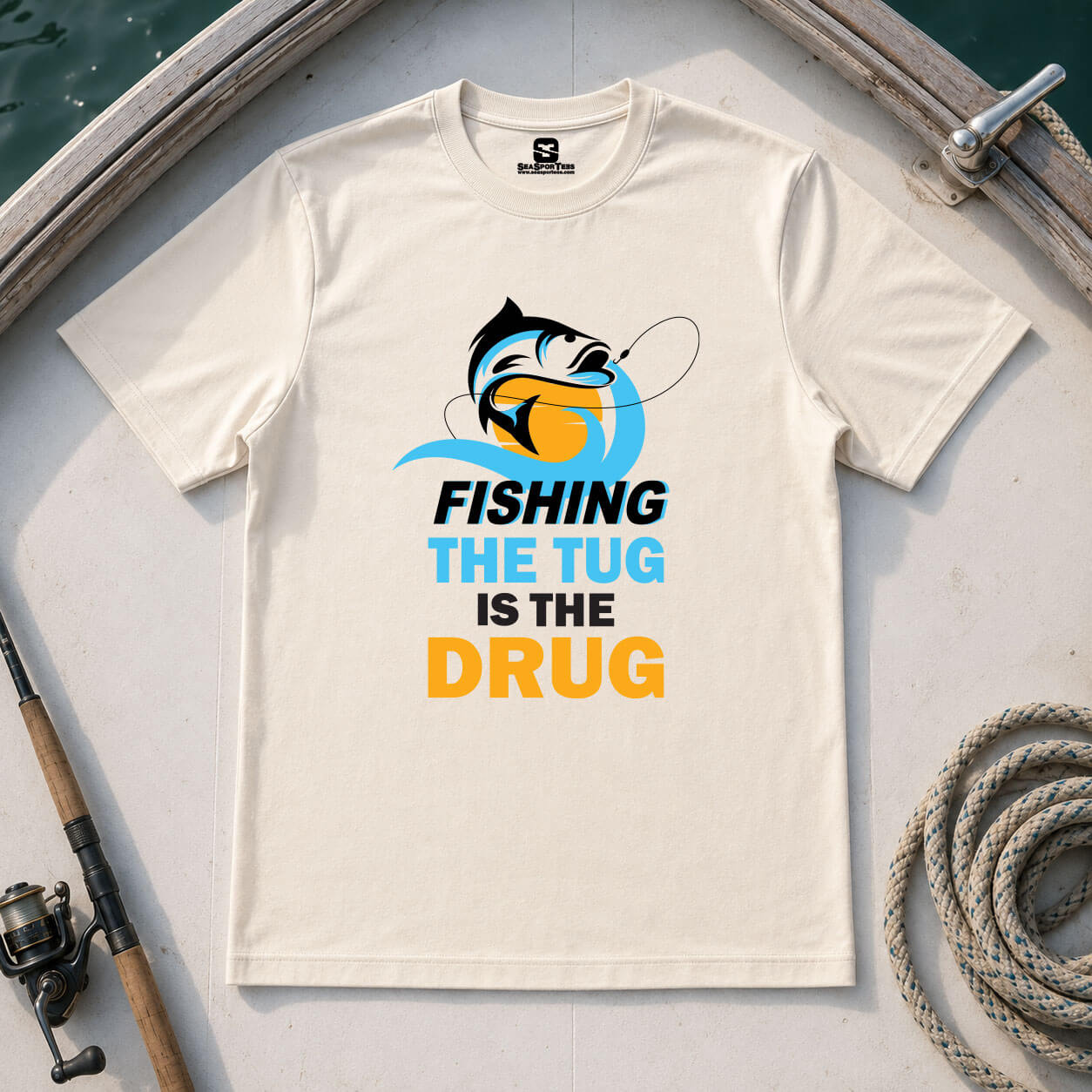 Fishing the Tug Is the Drug shirt on natural tee — bold fish graphic and typography — Seasportees fishing lifestyle tee